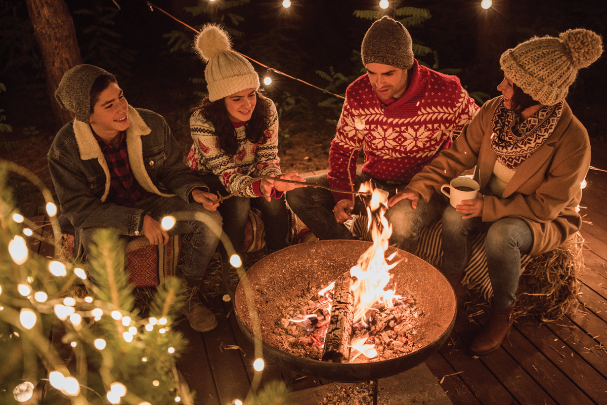 Maintain social distance at your outdoor gathering by seating family members together on one side of your fire.