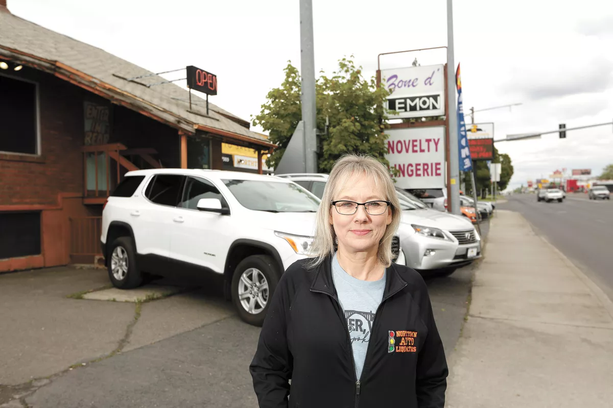 Kim Arrotta, co-owner of Northtown Auto Sales, was frustrated that a next-door business, a sex shop, remained open throughout the spring shutdown. - YOUNG KWAK PHOTO
