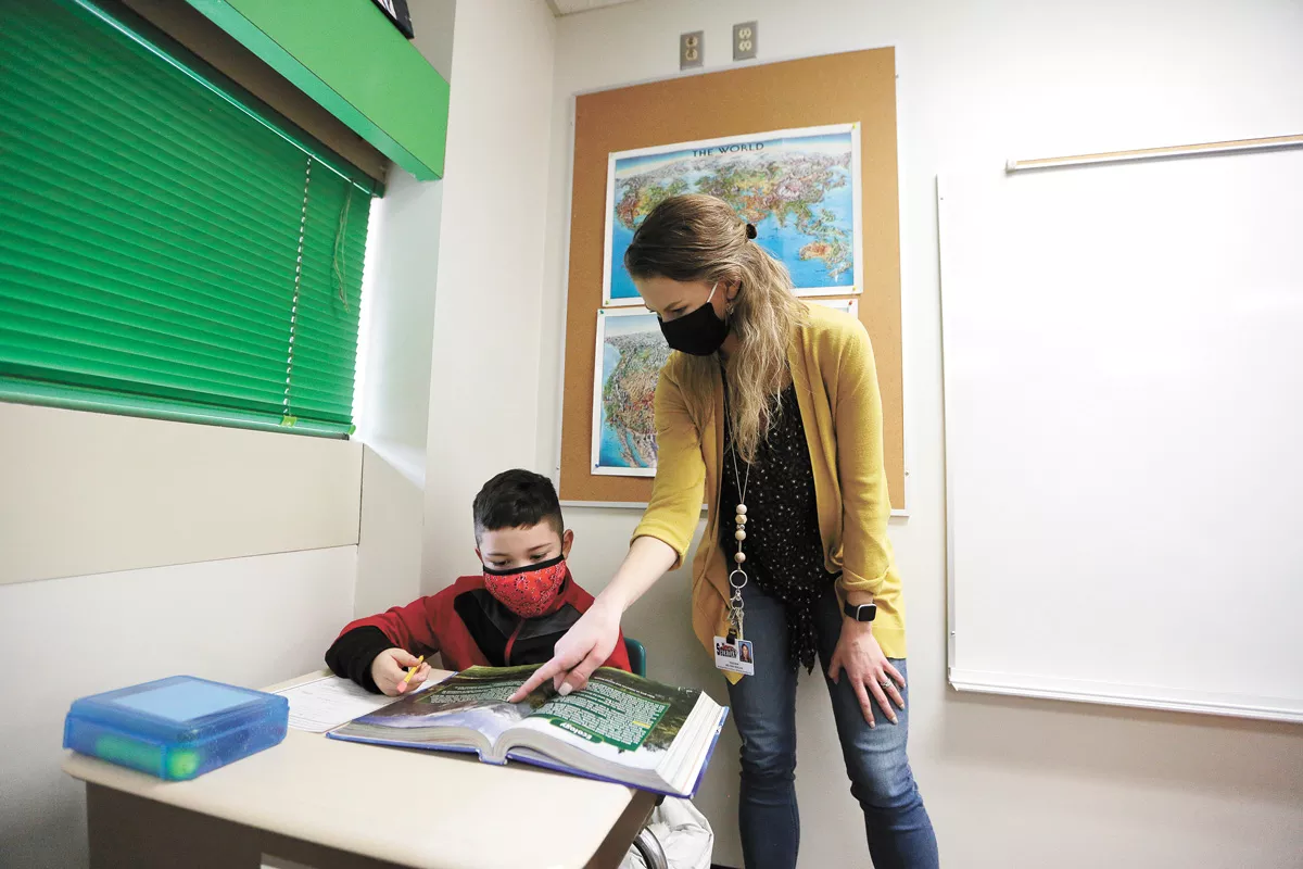 Sheridan Elementary fourth-grade teacher Melissa Beeler works with 10-year-old student Elijah. - YOUNG KWAK PHOTO