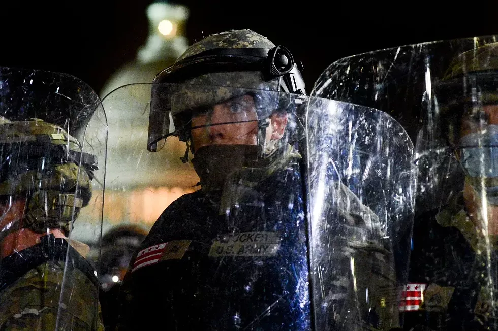 A member of the National Guard facing off with a mob of pro-Trump supporters in front of the Capitol in Washington, Jan. 6, 2021. New details about what authorities anticipated on Jan. 6 highlight failures to grasp the degree of the threat from pro-Trump right-wing extremists. - KENNY HOLSTON/THE NEW YORK TIMES