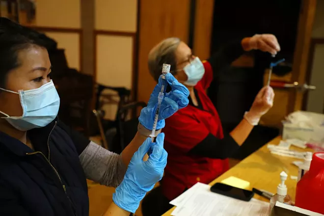 A coronavirus vaccine is prepared at a vaccine center in Rohnert Park, Calif., Jan. 27, 2021. - JIM WILSON/THE NEW YORK TIMES