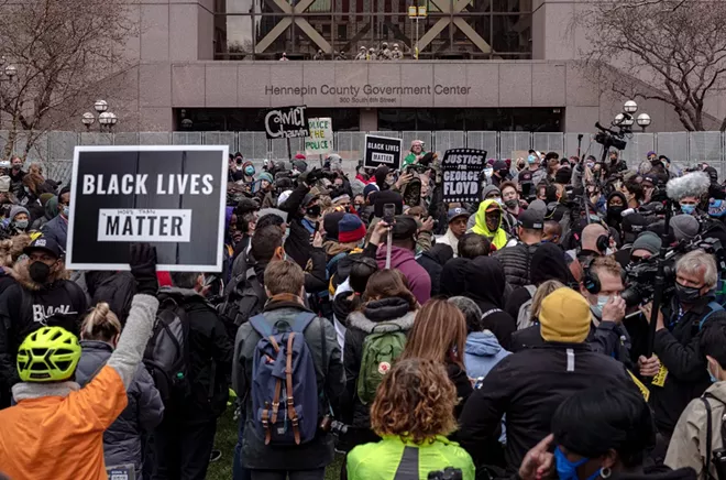 People gather outside the Hennepin Country Government Center in Minneapolis on Tuesday, April 20, 2021, as the jury prepares to deliver a verdict in the Derek Chauvin trial. Chauvin, a former Minneapolis police officer is charged in the death of George Floyd while in police custody last year. - AMR ALFIKY/THE NEW YORK TIMES