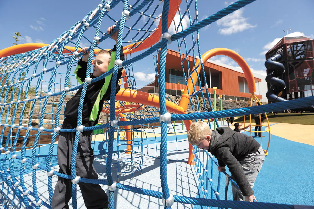 Five-year-olds Malachi Lovoy (left) and Lincoln Gowin climb at the Ice Age Floods Playground during the grand opening of the new North Bank area of Riverfront Park. - YOUNG KWAK PHOTO