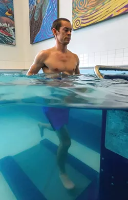Running on an underwater treadmill at Spokane's Physical Therapy Associates is popular with patients. "Most people are immediately in a good mood," says therapist Dylan Palmer. - DENIS KALAMAR PHOTO