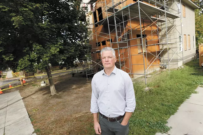 Todd Beyreuther, president of Spokane's Plan Commission, stands in front of a single-family home near Manito Park. The building used to be a duplex, but because of the city's restrictive zoning laws, the owner would not be allowed to convert the property back into a duplex. - YOUNG KWAK PHOTO