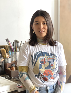 Jiemei Lin shows off one of her Terrain X T-shirt designs