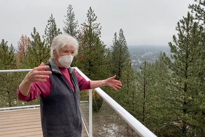 Donna McArthur describes her concerns with trees that have grown in below her property. - SAMANTHA WOHLFEIL PHOTO