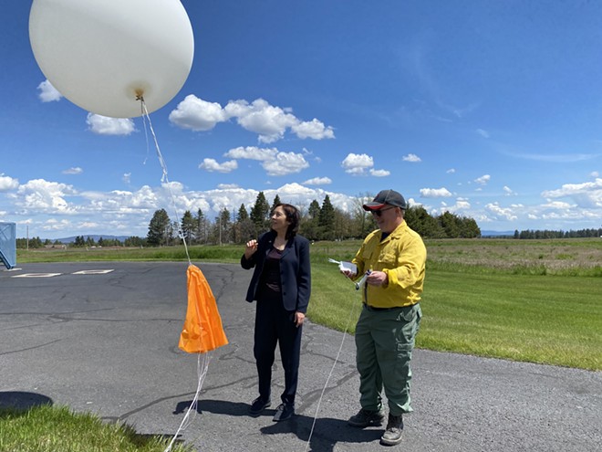 U.S. Sen. Maria Cantwell (D-WA) releases a weather balloon on June 1, 2022, as incident meteorologist Jon Fox (right) stands by and later shows her the detailed data it relays to teams on the ground. - SAMANTHA WOHLFEIL PHOTO