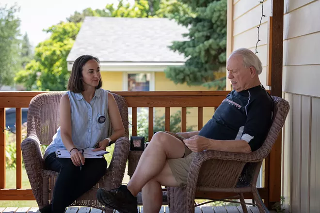 Spokane County Commissioner candidate Maggie Yates chats with Cheney resident John Statham while campaigning Saturday. - ERICK DOXEY PHOTO