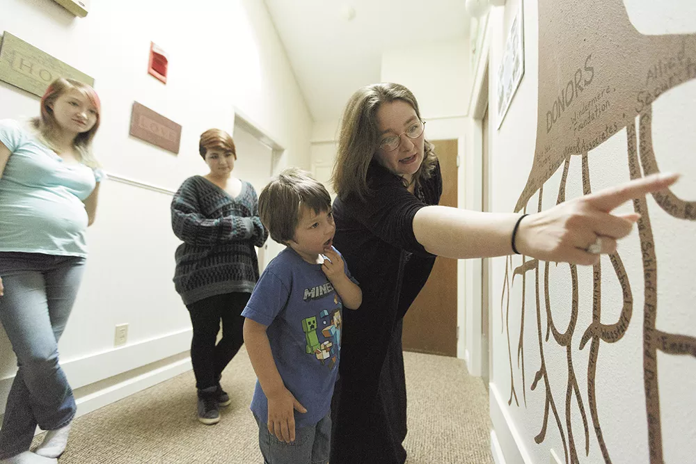 Angela Friedrich shows her 5-year-old son, Bert, a mural representing the donors who contributed to Family Promise of Spokane, which has helped the Friedrich family. - YOUNG KWAK