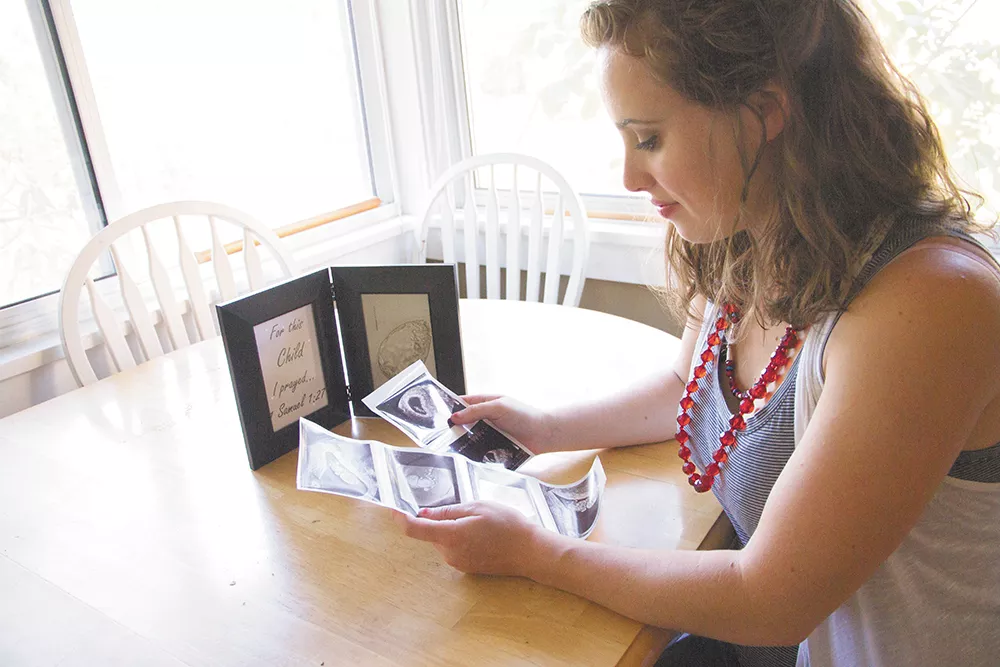 As she looks at sonograms, McNamara reflects on the process of getting pregnant. - JENNIFER DEBARROS PHOTO