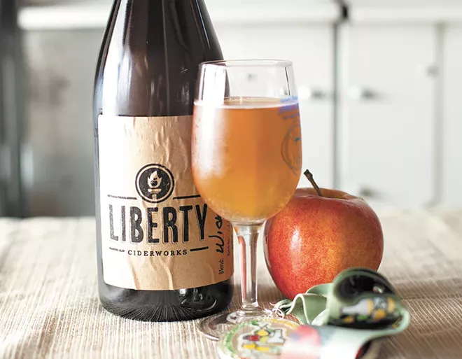 Liberty Ciderworks co-owners Rick Hastings, left, and Austin Dickey monitor the juice produced from milled apples. - YOUNG KWAK
