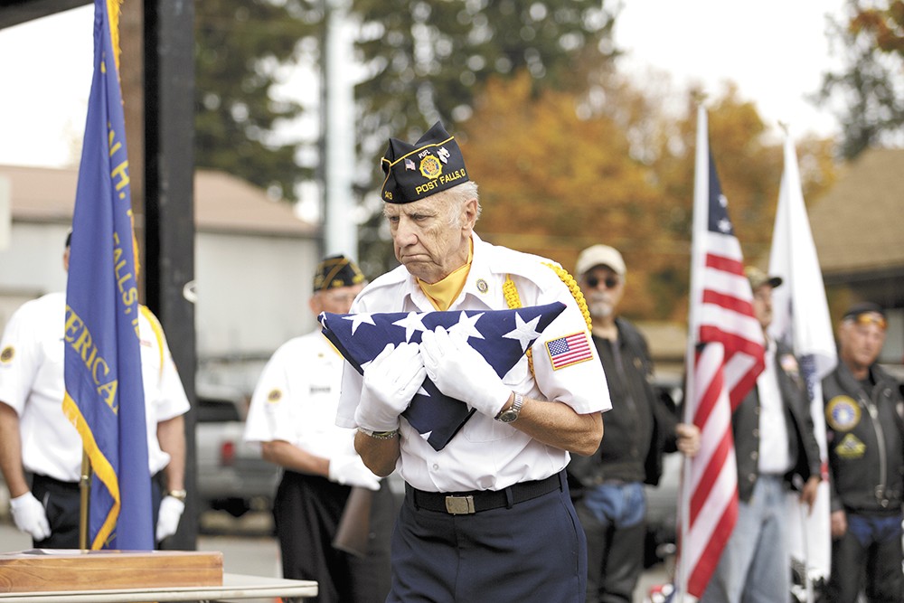 Sgt. Harold Markiewicz, a member of American Legion Post 143 in Post Falls, delivers a flag to Parkinson's family in his honor. - YOUNG KWAK