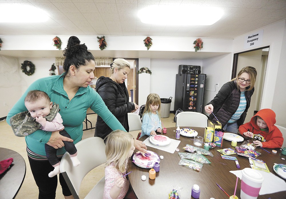 Melissa Strohe (left) and other mothers help their kids with a crafts activity during one of the North Spokane MOMS Club's weekly social events. - YOUNG KWAK