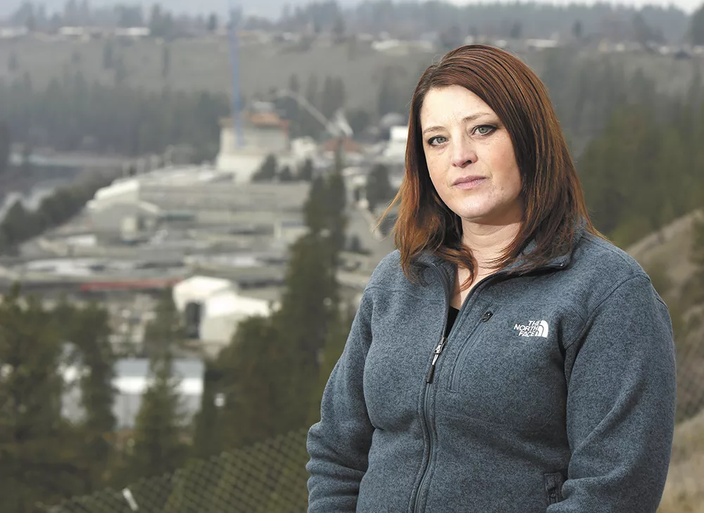Sonya O'Brien stands on a bluff overlooking Riverside Park Water Reclamation Facility. She worked as an operator there for five years before being forced out due to what she says was a hostile work environment. - YOUNG KWAK