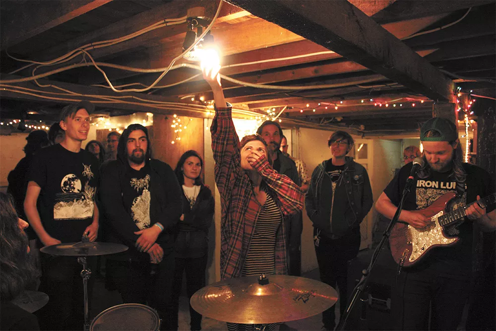 Bayou tenant Allyson Amstutz (center) turns off the basement light for Spokane band Deformer last weekend. - LAURA JOHNSON