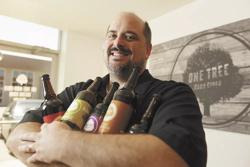 One Tree Hard Cider's Neal Hennessy with several varieties of his company's award-winning cider. - YOUNG KWAK