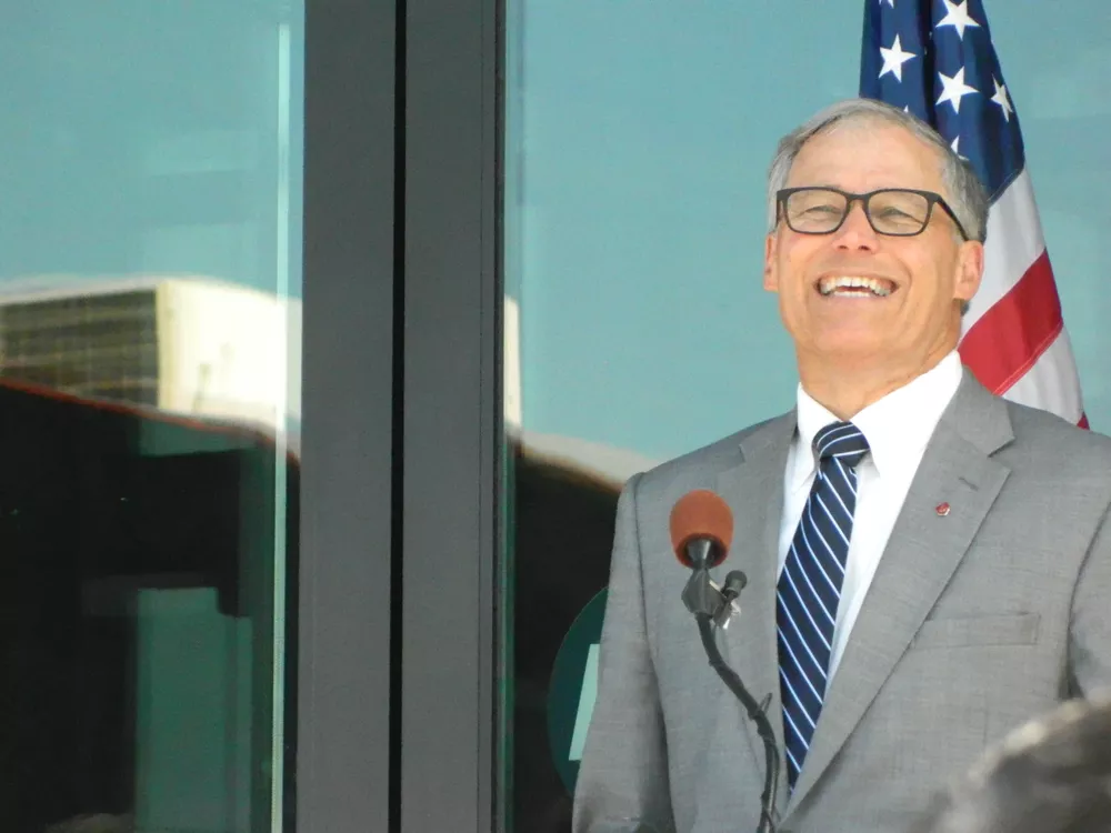 Washington Gov. Jay Inslee had a laugh as oil-train protestors confronted a smiling President Barack Obama at a fundraiser.