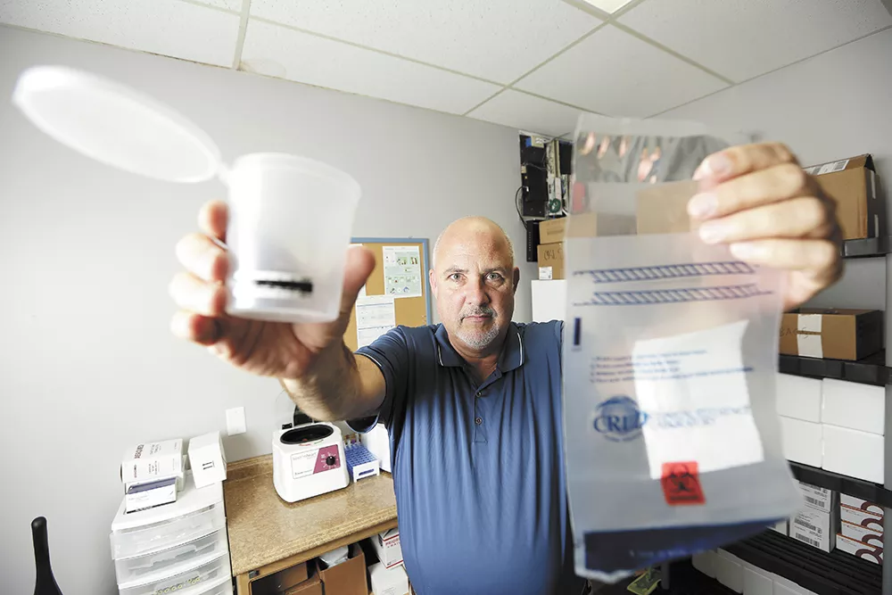 Doug Thayer, owner of a local franchise of ARCpoint Labs, consults businesses on how to protect themselves from employees who show up to work high. He says there's currently no good way to check if an employee is under the influence of cannabis while at work. - YOUNG KWAK