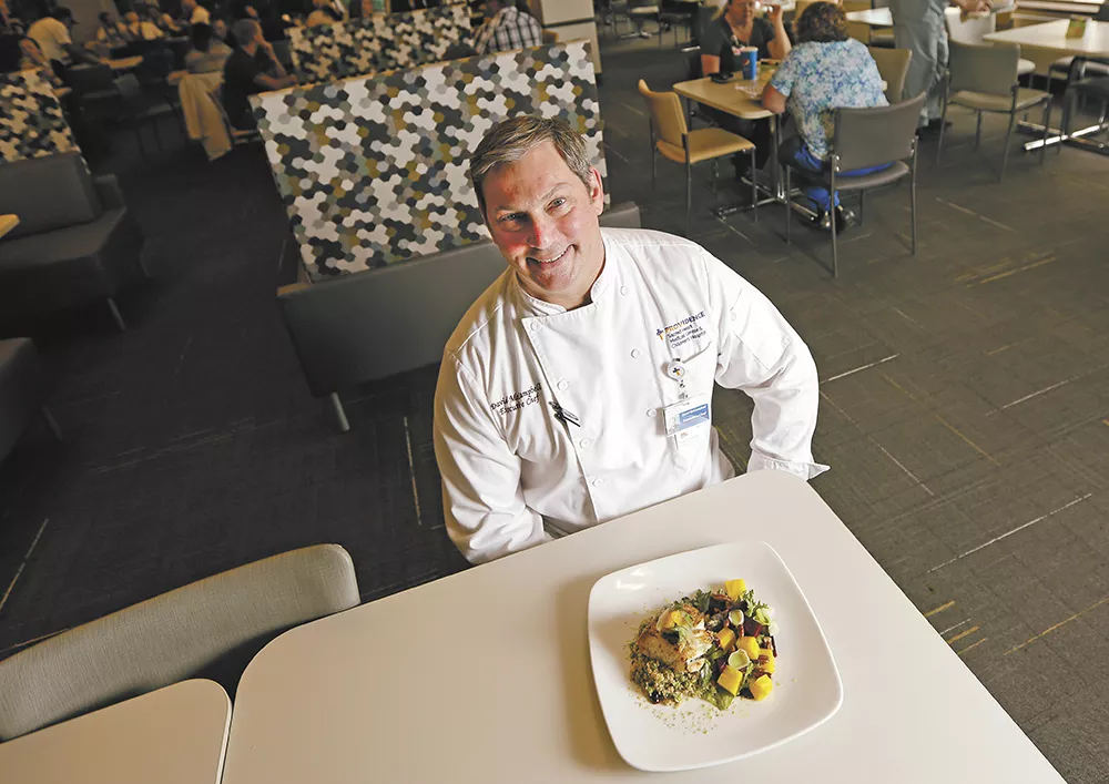 Chef David McCampbell in the Sacred Heart dining room with his grilled halibut: "I want to make the healthy option, the easy option." - YOUNG KWAK