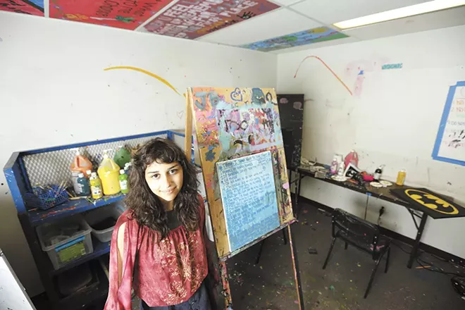 Angelina ended up in The Jungle, Seattle's infamous homeless encampment, where she says she was sold to a man in exchange for drugs. Here she's seen next to a painting she made during her in-patient treatment at Daybreak Youth Services in Spokane. - YOUNG KWAK