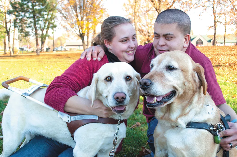 Katrina and Ryan Strickland with their service dogs, Madison and Huntley, at Franklin Park in Spokane. - SARAH PHILP