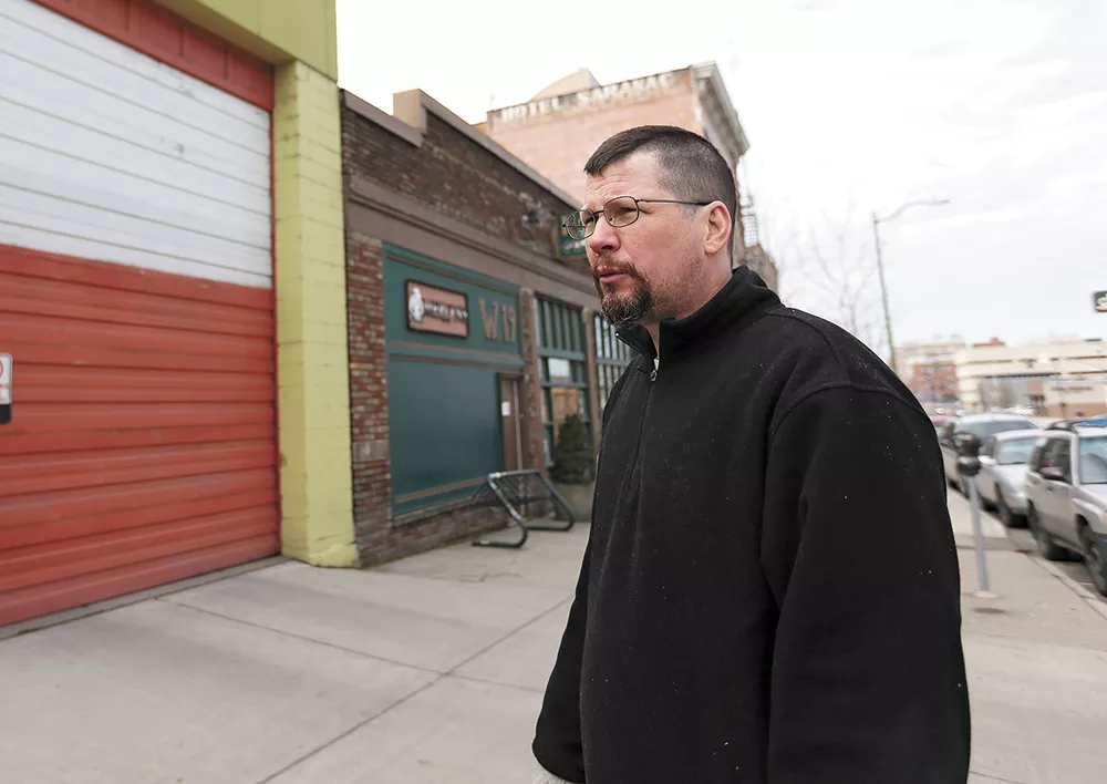 John Waite, owner of Merlyn's and Auntie's Bookstore, is counting on increased sales to make up for the cost of paying his employees more. - YOUNG KWAK