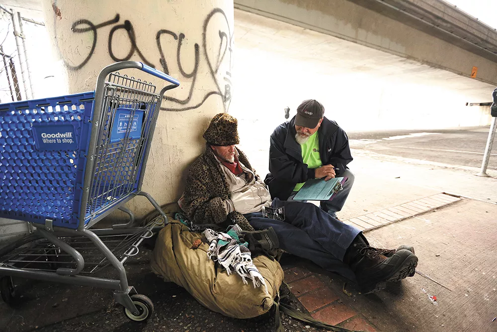 Social worker Bob Peeler talks to Anthony St. John about ways he might get off the street. - YOUNG KWAK