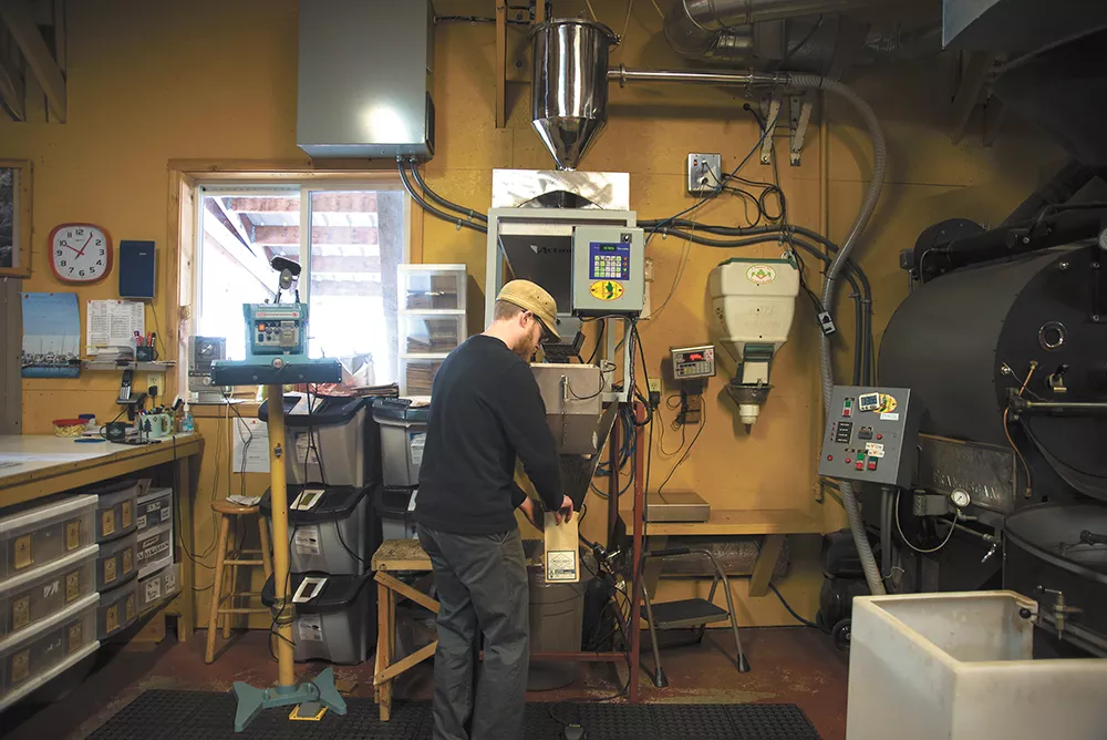 Chris Malberg fills a bag with freshly roasted beans at Landgrove Coffee roasters in Troy, Idaho. - TARYN PHANEUF