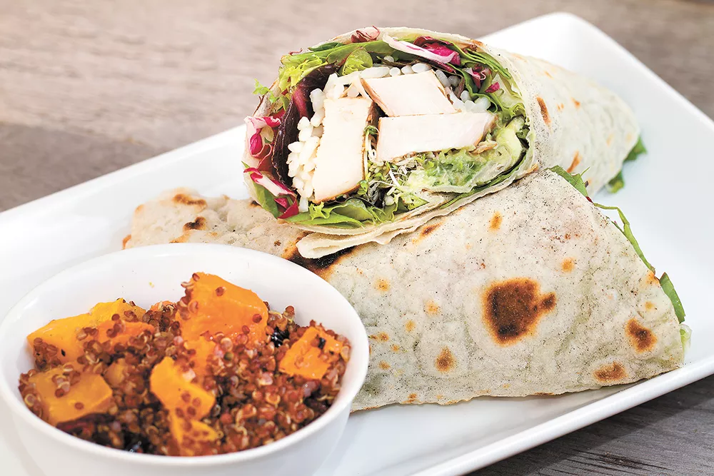 The Yardbird wrap comes packed with grilled chicken, spicy rice, spring greens and housemade guacamole. - BRETT FONTANA