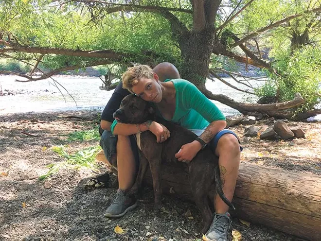 Destiny Brown, a homeless woman from Pennsylvania, and her dog Mister were forced to leave an area where she had been camping on the north bank of the Spokane River, below Kendall Yards. - MITCH RYALS PHOTO