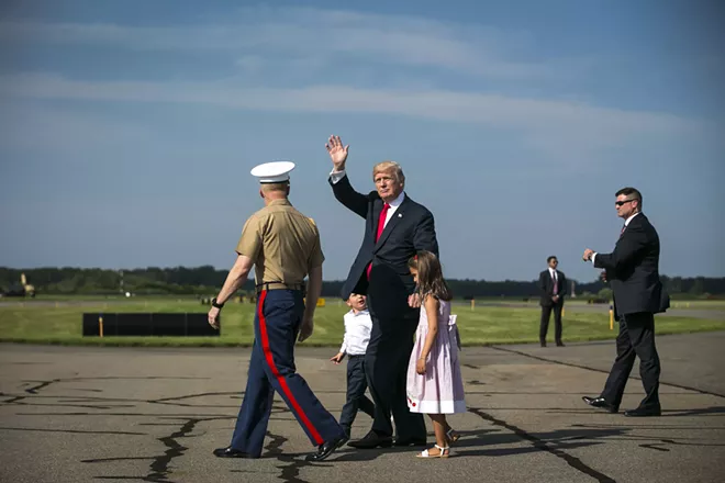 President Donald Trump walks with a military aide and his grandchildren, Arabella and Joseph Kushner, at Morristown Municipal Airport to begin his summer vacation at his Bedminster golf club, Aug. 4, 2017. - AL DRAGO/THE NEW YORK TIMES