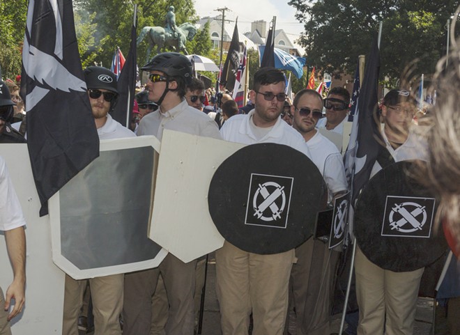 James Alex Fields, Jr., center with black shield, gathered with other demonstrators at a statue of Robert E. Lee that was planned to be removed in Charlottesville, Va., during a so-called “Unite the Right” rally, Aug. 12, 2017. Fields, suspected of ramming his car into a crowd in Charlottesville, an attack that authorities said left one person dead and 19 more injured, was denied bail during his first court appearance in a downtown courtroom on Monday. - MATT EICH/THE NEW YORK TIMES
