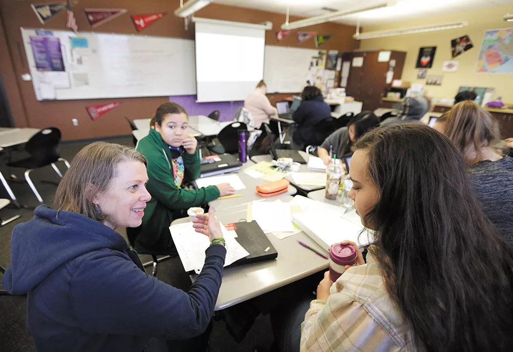 Teacher Beth McGibbon (left) works with Jamie Cahill during an AP Capstone class at Rogers High School. - YOUNG KWAK