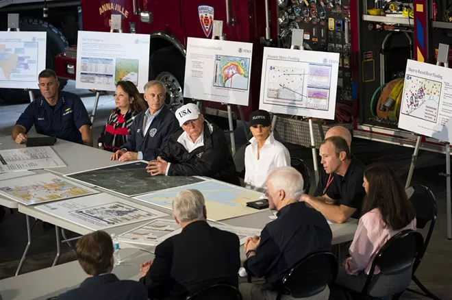 President Donald Trump participates in a briefing on relief efforts following Hurricane Harvey, at a fire station in Corpus Christi, Texas, Aug. 29, 2017. After conferring with local, state and federal emergency management officials here, Trump plans to travel to Austin, the state capital. Seated next to Trump are Gov. Greg Abbott of Texas and first lady Melania Trump. - DOUG MILLS/THE NEW YORK TIMES