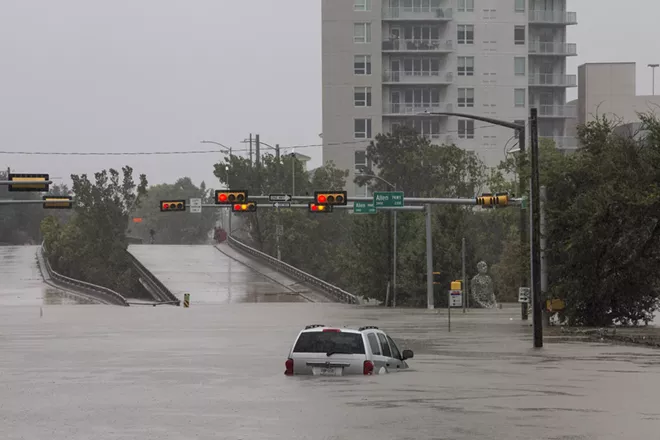 A car caught in the flooding along Buffalo Bayou and Allen Parkway in Houston, Aug. 28, 2017. With record floodwaters devastating much of southeast Texas, more than 450,000 people are likely to seek federal aid in recovering from Harvey, the storm that has battered the Gulf Coast for days, a Federal Emergency Management Agency official said. - SCOTT DALTON/THE NEW YORK TIMES