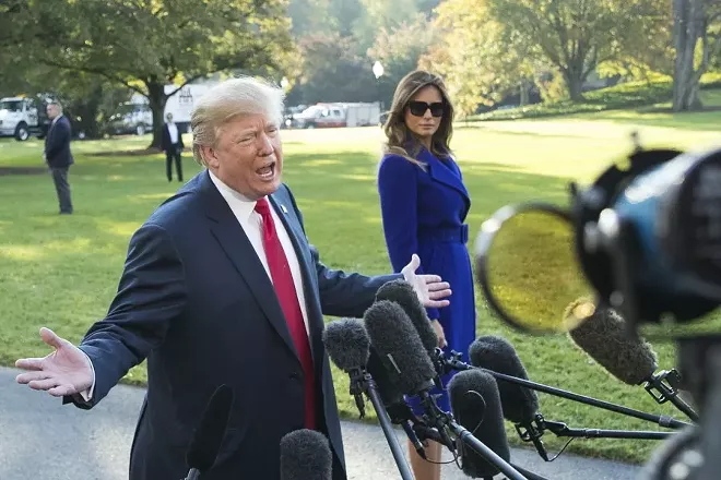 President Donald Trump speaks to reporters, as first lady Melania Trump looks on, before boarding Marine One for a trip to Hawaii and later Asia, at the White House in Washington, Nov. 3, 2017. Frustrated with the Justice Department’s reluctance to investigate his political opponents, Trump on Friday said he would like the agency to run itself, but he and “a lot of people” are disappointed in the top federal law enforcement agency. - TOM BRENNER/THE NEW YORK TIMES