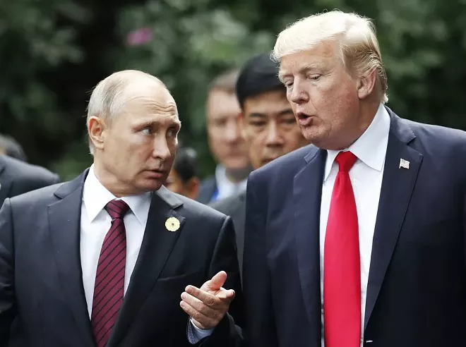 President Donald Trump and President Vladimir Putin of Russia converse as leaders participating in the APEC summit took a group photo, in Danang, Vietnam, Nov. 11, 2017. Trump said on Saturday that he believed Putin’s denials of interference in the 2016 presidential elections were sincere. “Every time he sees me he says, ‘I didn’t do that,’ and I really believe that when he tells me that, he means it,” Trump said. - JORGE SILVA/POOL VIA THE NEW YORK TIMES