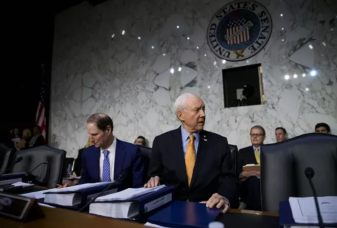 Sen. Orrin Hatch (R-Utah) chairs a Senate Finance Committee executive session on tax policy, on Capitol Hill in Washington, Nov. 15, 2017. Senate Republicans have decided to include the repeal of the Affordable Care Act’s requirement that most people have health insurance into the sprawling tax rewrite. At left is Sen. Ron Wyden (D-Ore.), the ranking Democrat on the committee. - ERIC THAYER/THE NEW YORK TIMES