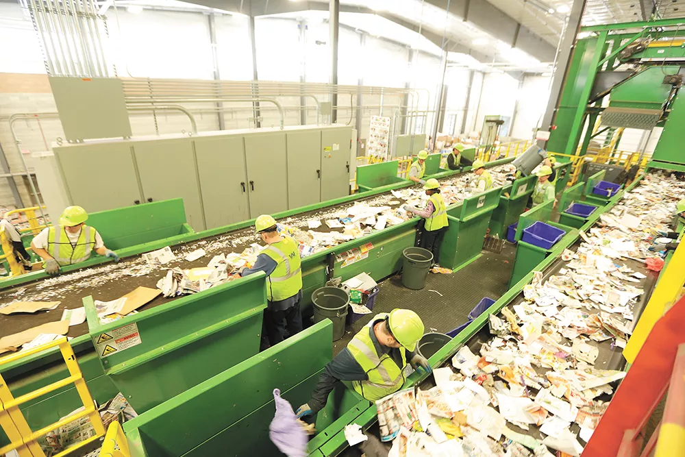 Employees at facilities like Spokane's SMaRT Center hand-pick garbage from the recycling material. - YOUNG KWAK
