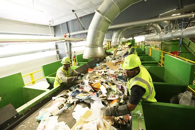 Presort Lead Jameel Henricksen, right, and Sorter Jerome Thomas remove plastic bags at Waste Management's SMaRT Center in Spokane. - YOUNG KWAK