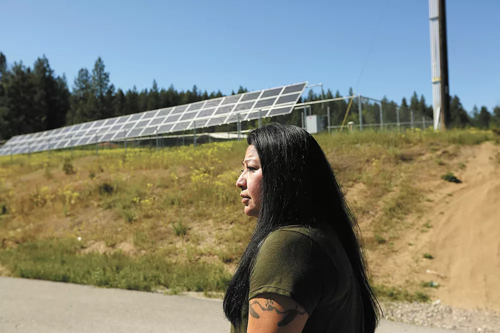 The Spokane Tribe’s Planning Manager Maria Cullooyah, in front of new solar panels in Wellpinit, Wash. - YOUNG KWAK