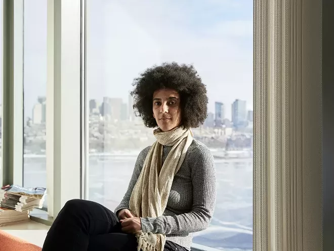 Timnit Gebru, who led a research effort based at Stanford University that analyzed 50 million images and location data from Google Street View, in Boston, Dec. 29, 2017. Artificial intelligence is making it possible for Street Views to be mined for insights about the economy, politics and human behavior — just as text mining has done for years. “This kind of social analysis using image data is a new tool to draw insights,” she said. - CODY O'LAUGHLIN/THE NEW YORK TIMES