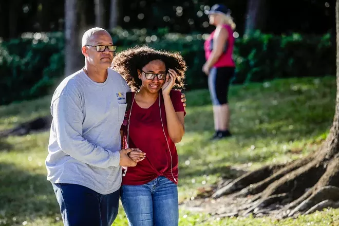 A father and daughter embrace after a mass shooting at the Marjory Stoneman Douglas High School in Parkland, Fla., Feb. 14, 2018. At least 17 people were killed Wednesday at this school about an hour northwest of Miami, law enforcement officials said. A suspect, a former student, is in custody. - SAUL MARTINEZ/THE NEW YORK TIMES