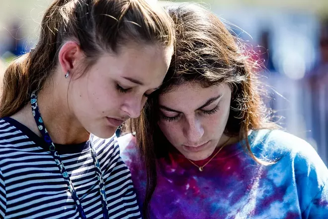 Students attend a prayer service at Parkridge Church in Coral Springs, Fla., a day after a mass shooting occurred at the nearby Marjory Stoneman Douglas High School, Feb. 15, 2018. Authorities on Thursday charged 19-year-old Nikolas Cruz – who is suspected of gunning down students and adults at the school – with 17 counts of premeditated murder. - SAUL MARTINEZ/THE NEW YORK TIMES