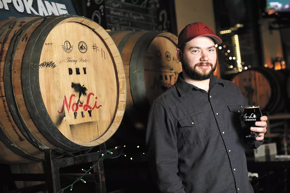 No-Li head brewer Ryan Brookhart with a glass of "Rip Van Winkle," a whiskey barrel-aged imperial stout. - YOUNG KWAK
