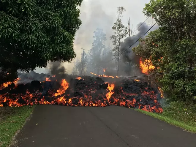 A photo provided by the U.S. Geological Survey shows lava flow moving on Makamae Street in Leilani Estates, near Pahoa, Hawaii, May 6, 2018. More than two dozen homes have been destroyed since the Kilauea volcano began erupting last week, officials said on Sunday, as at least 10 fissures emerged, spewing lava into residential neighborhoods on the eastern edge of the island of Hawaii. - U.S. GEOLOGICAL SURVEY VIA THE NEW YORK TIMES