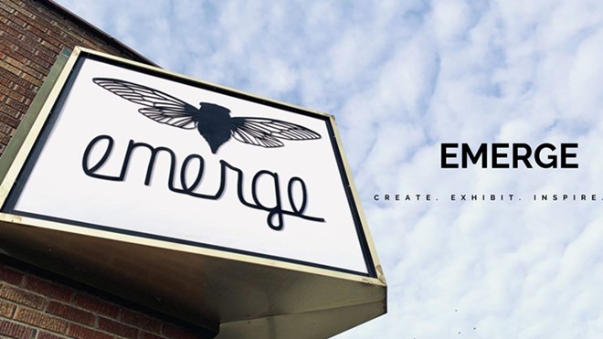 Emerge sign with sky in background. Text reads 'Emerge. Create. Exhibit. Inspire"