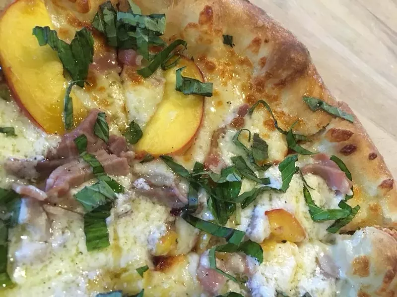Don't wait to enjoy this popular seasonal pie, topped with fresh Green Bluff peaches. - SOUTH PERRY PIZZA
