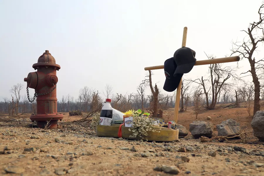 A makeshift memorial honors Jeremy Stoke, a Redding firefighter who died, in a burned area in Redding, Calif., Aug. 1, 2018. Officials said the Carr Fire was one of 17 major fires across California that have consumed more than 450,000 acres. Gov. Jerry Brown called it the “new normal.” - JIM WILSON/THE NEW YORK TIMES
